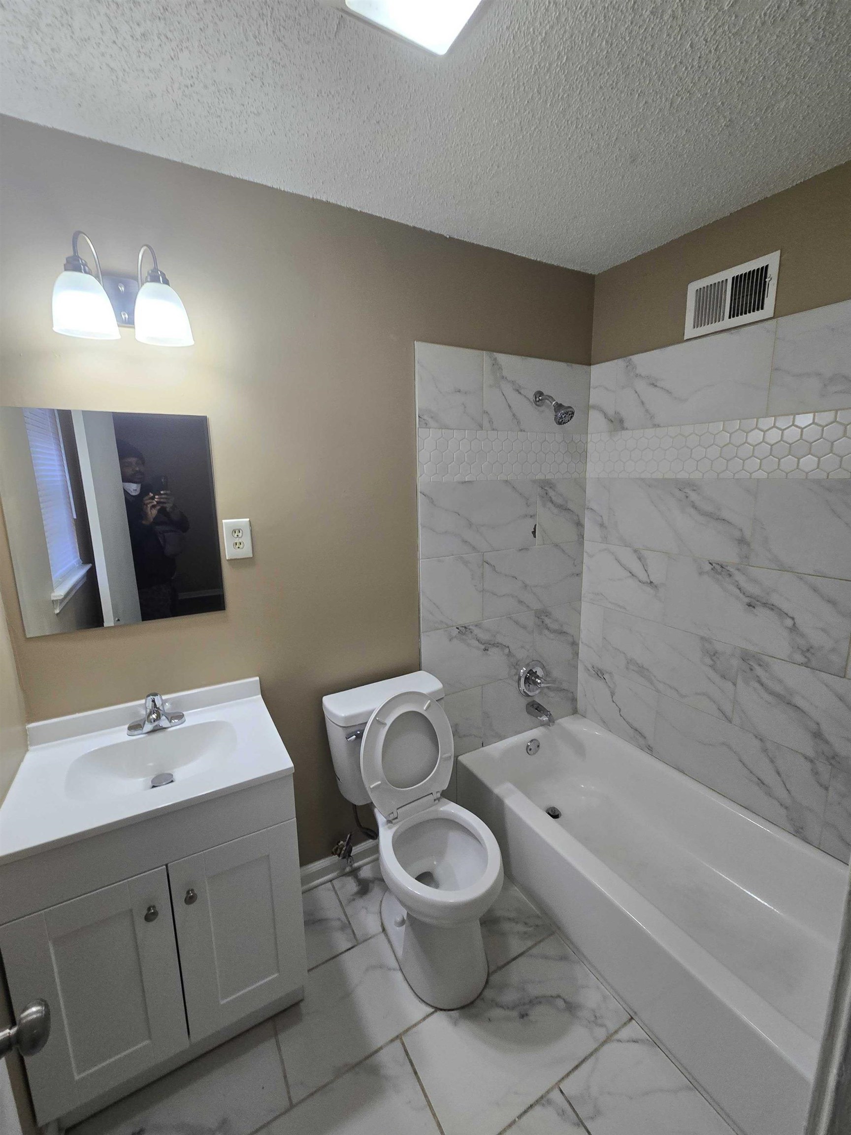 4511 Sumners Wells Road Memphis, TN 38118 - Photo 2 of 8 a bathroom with a toilet sink and mirror