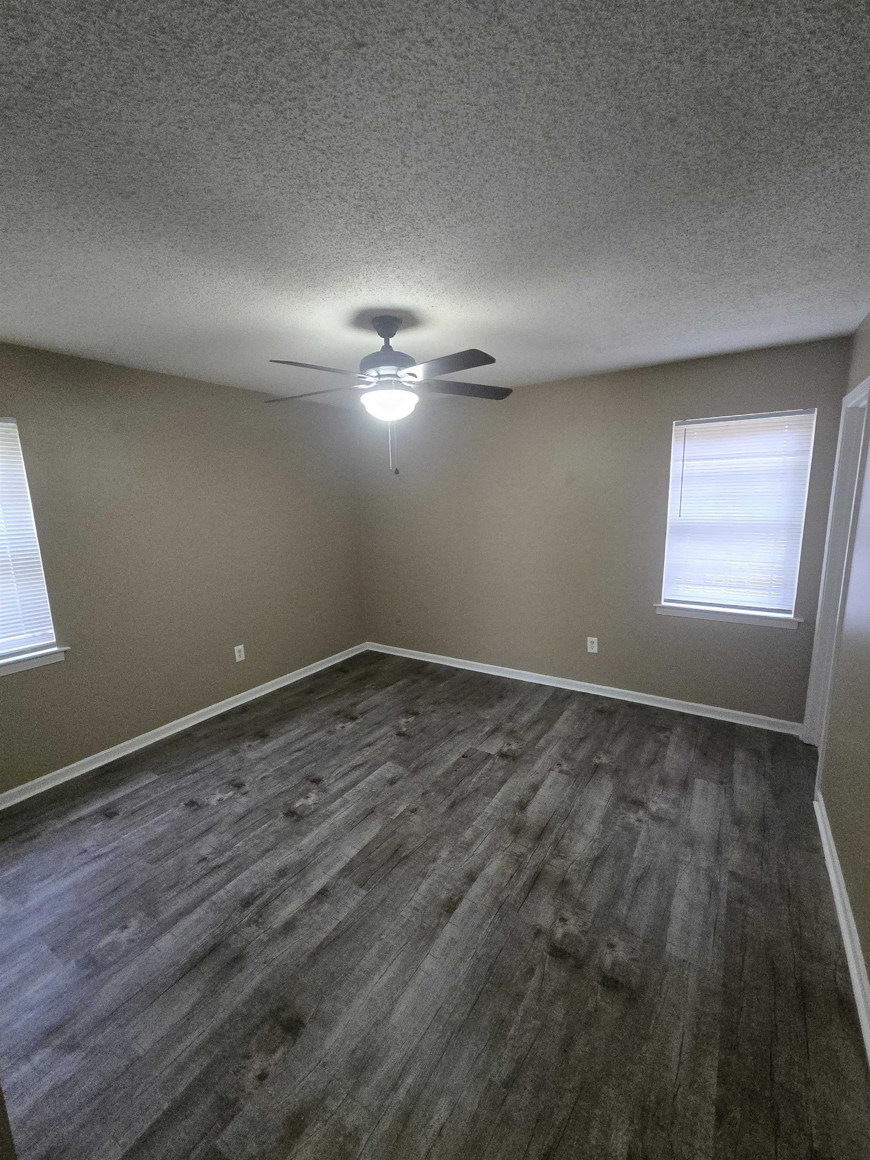 4511 Sumners Wells Road Memphis, TN 38118 - Photo 3 of 8 an empty room with a empty space and windows