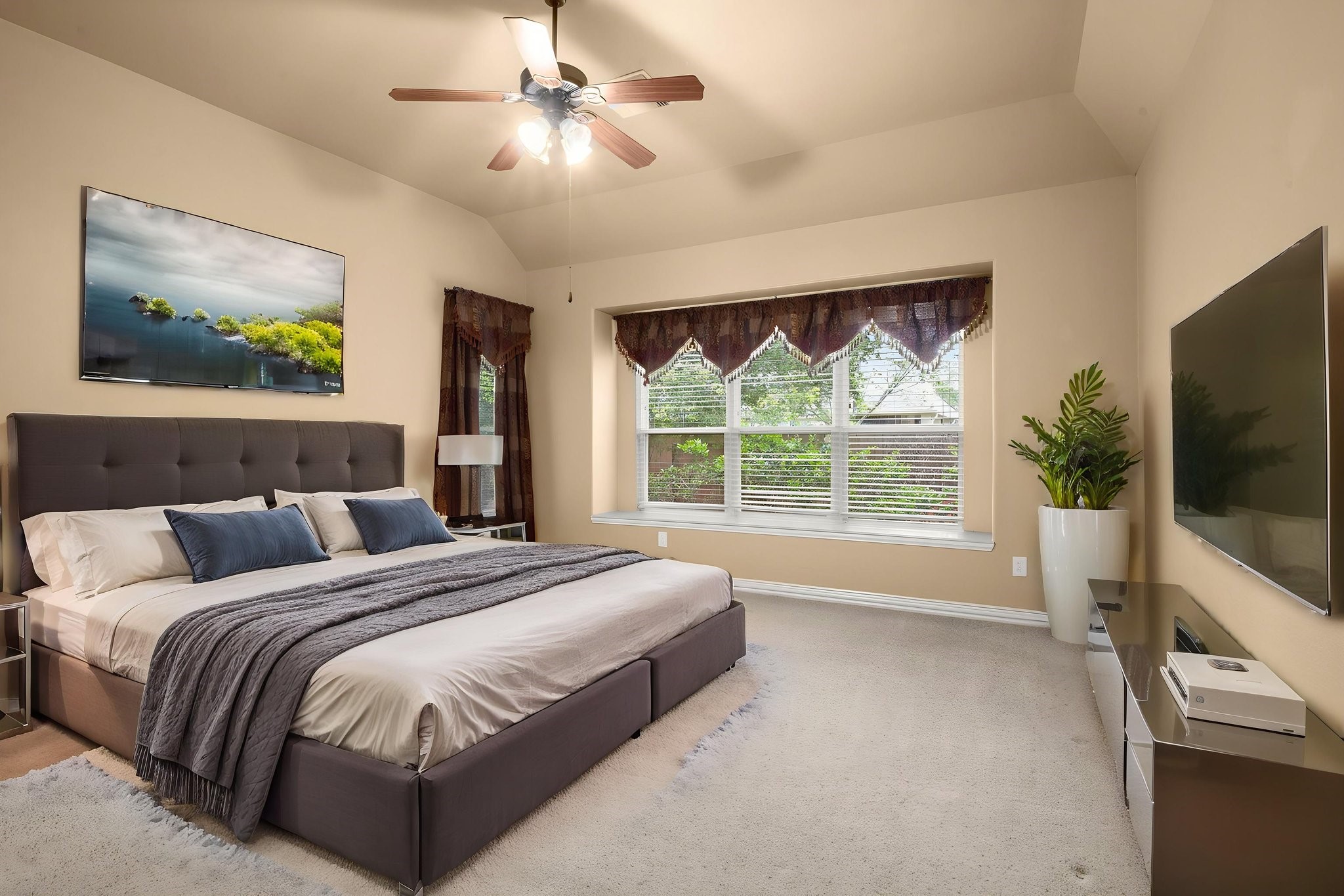 110 David Forest Lane Conroe, TX 77384 - Photo 29 of 35 a bedroom with a large bed and a flat tv screen on dresser