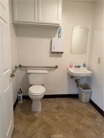 a bathroom with a toilet sink and mirror