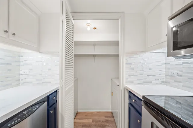 a view of a kitchen cabinets and a counter top space
