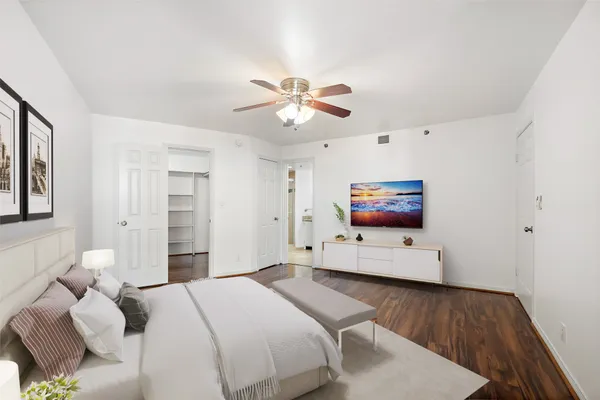 a bedroom with a bed and a flat screen tv