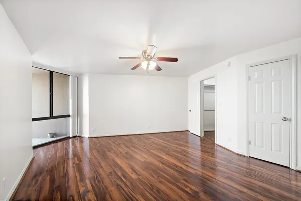 a view of empty room with wooden floor