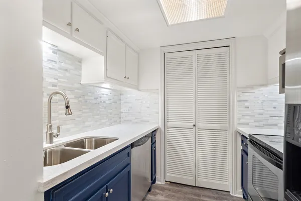 a kitchen with a sink and cabinets