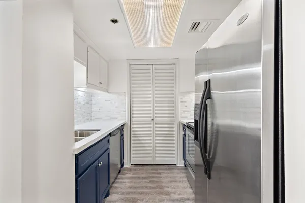 a kitchen with stainless steel appliances granite countertop a refrigerator and a sink