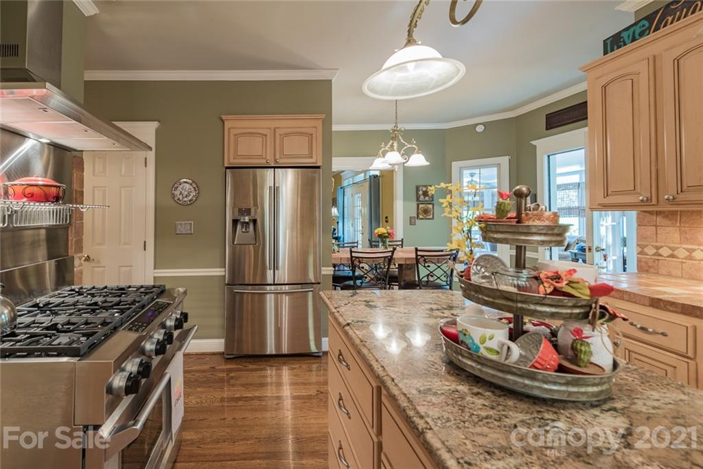 131 Friendfield Drive Fort Mill, SC 29715 - Photo 15 of 46 a kitchen with stainless steel appliances granite countertop a sink stove and refrigerator