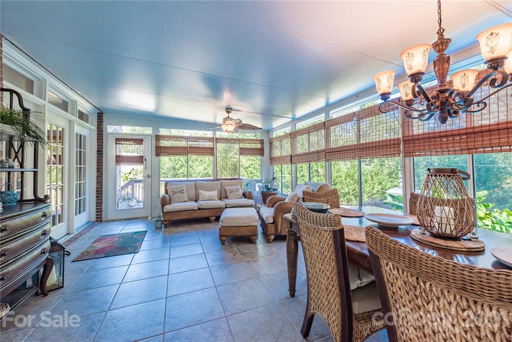 131 Friendfield Drive Fort Mill, SC 29715 - Photo 22 of 46 a view of a dining room with furniture large windows and a chandelier
