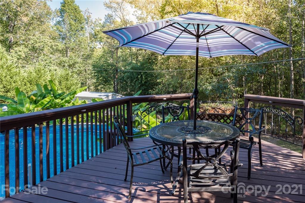 131 Friendfield Drive Fort Mill, SC 29715 - Photo 38 of 46 a patio with wooden floor a yard a table and chairs