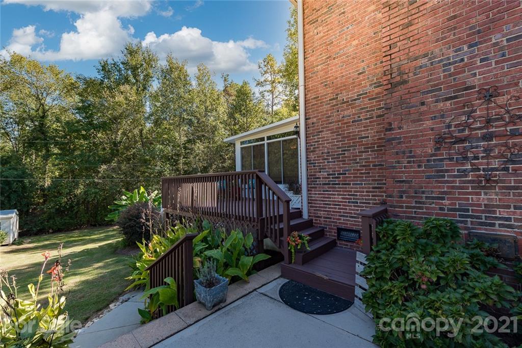 131 Friendfield Drive Fort Mill, SC 29715 - Photo 43 of 46 a view of a garden with a bench in patio