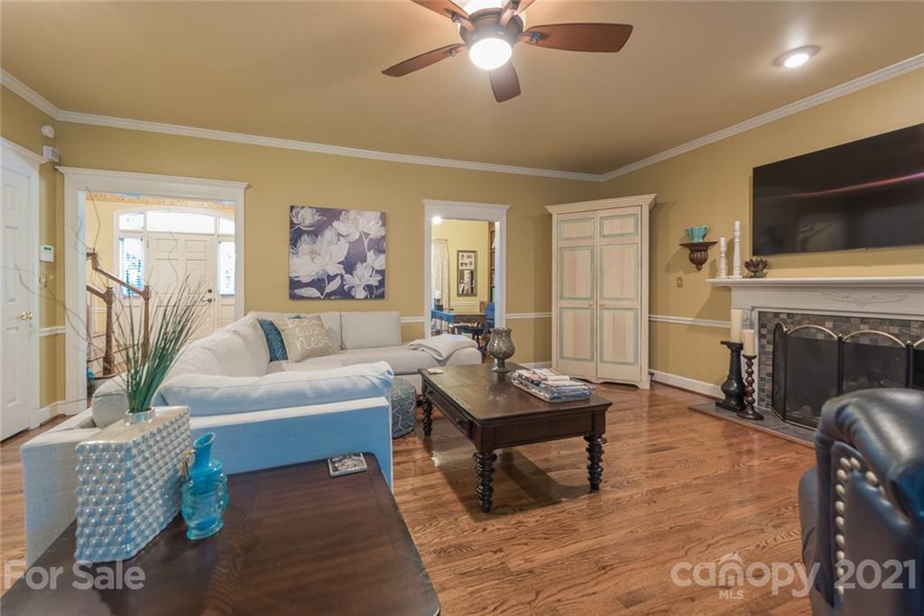 131 Friendfield Drive Fort Mill, SC 29715 - Photo 8 of 46 a living room with furniture a fireplace and a flat screen tv