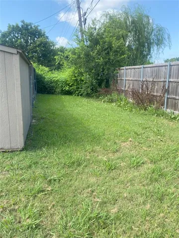 a view of field with trees in the background