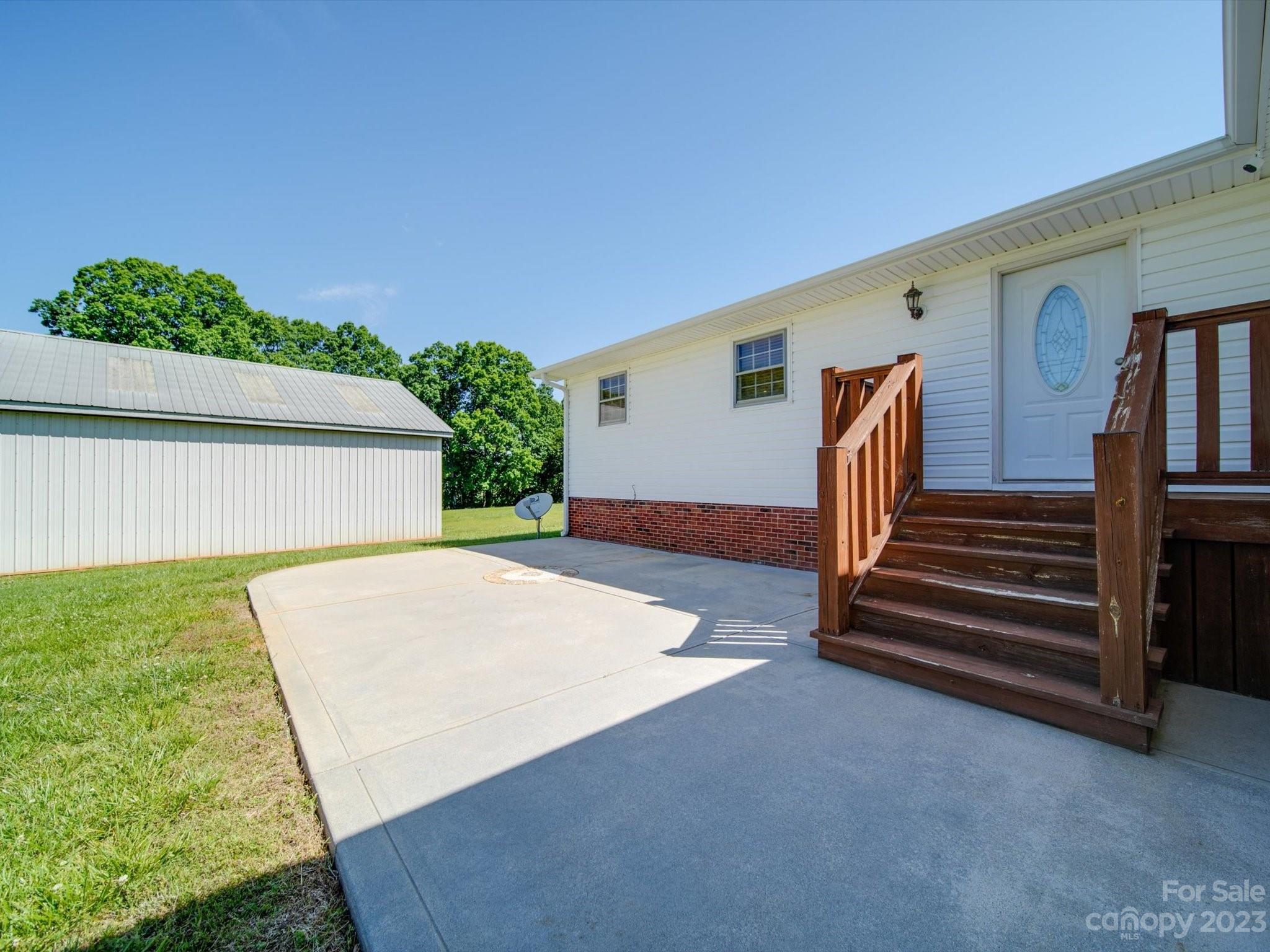 1004 Austin Chaney Road Wingate, NC 28174 - Photo 11 of 48 a backyard of a house with wooden floor and stairs