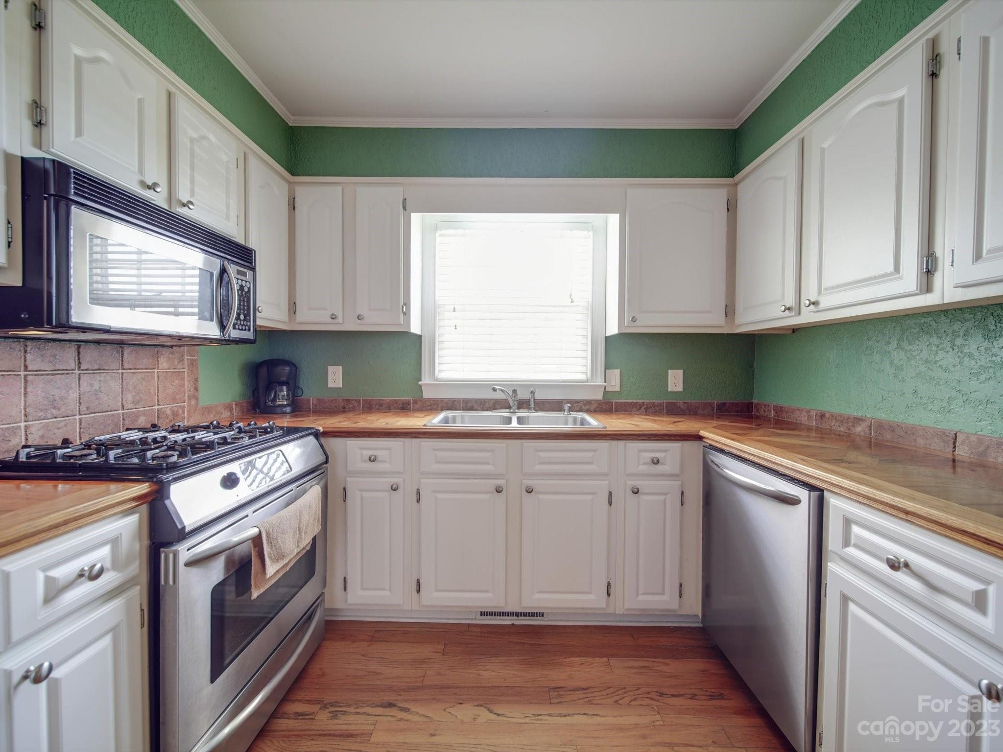 1004 Austin Chaney Road Wingate, NC 28174 - Photo 23 of 48 a kitchen with granite countertop cabinets stainless steel appliances and a window