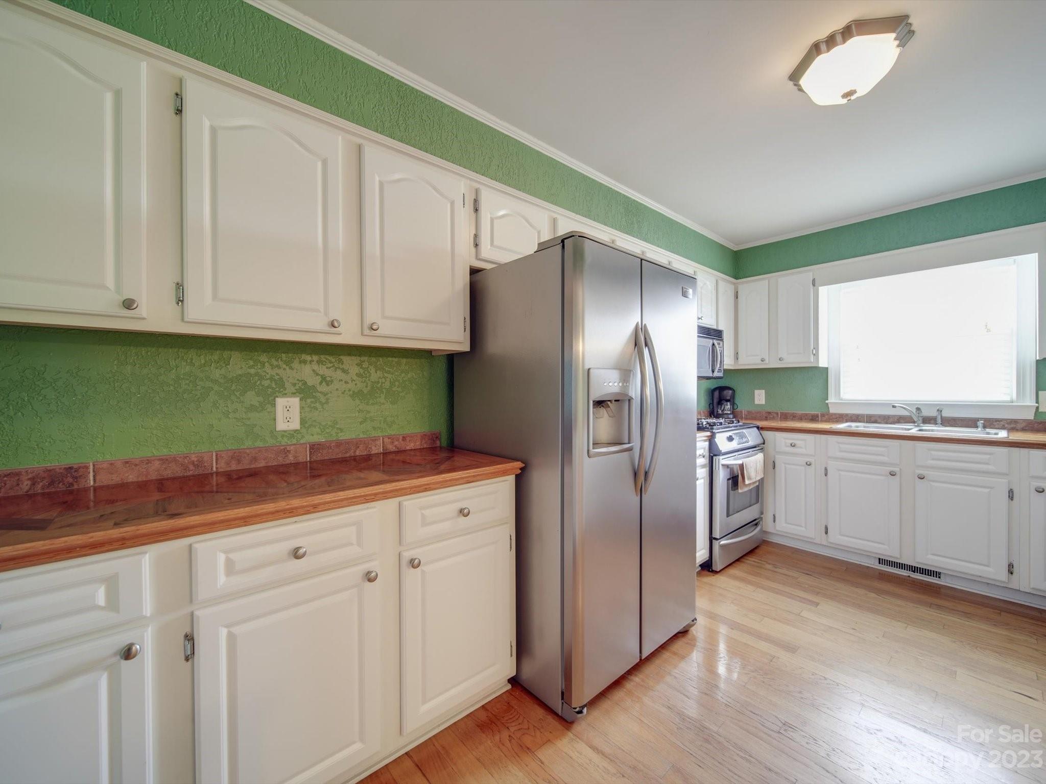 1004 Austin Chaney Road Wingate, NC 28174 - Photo 24 of 48 a kitchen with granite countertop white cabinets and stainless steel appliances