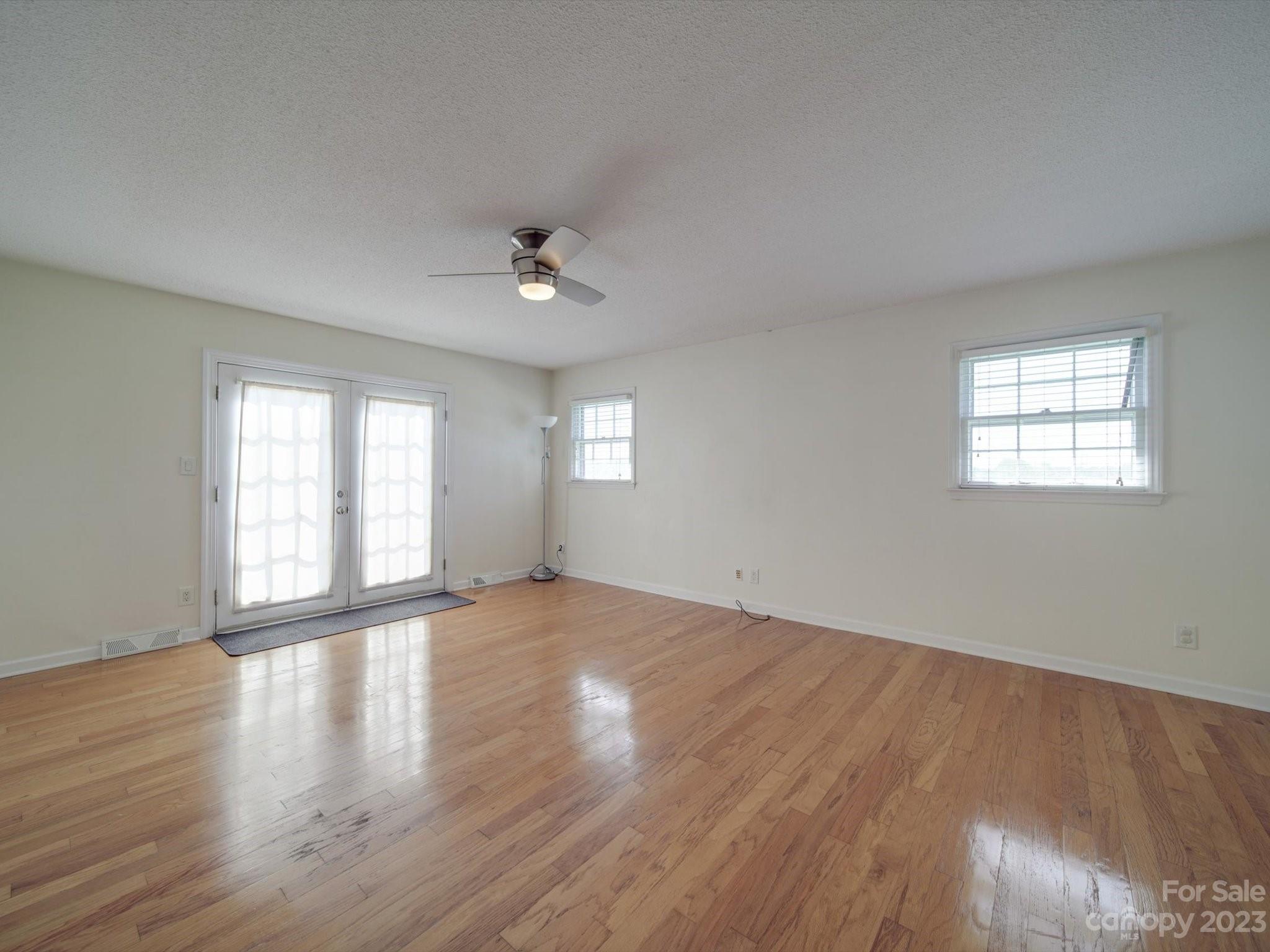 1004 Austin Chaney Road Wingate, NC 28174 - Photo 28 of 48 a view of an empty room with a window and wooden floor