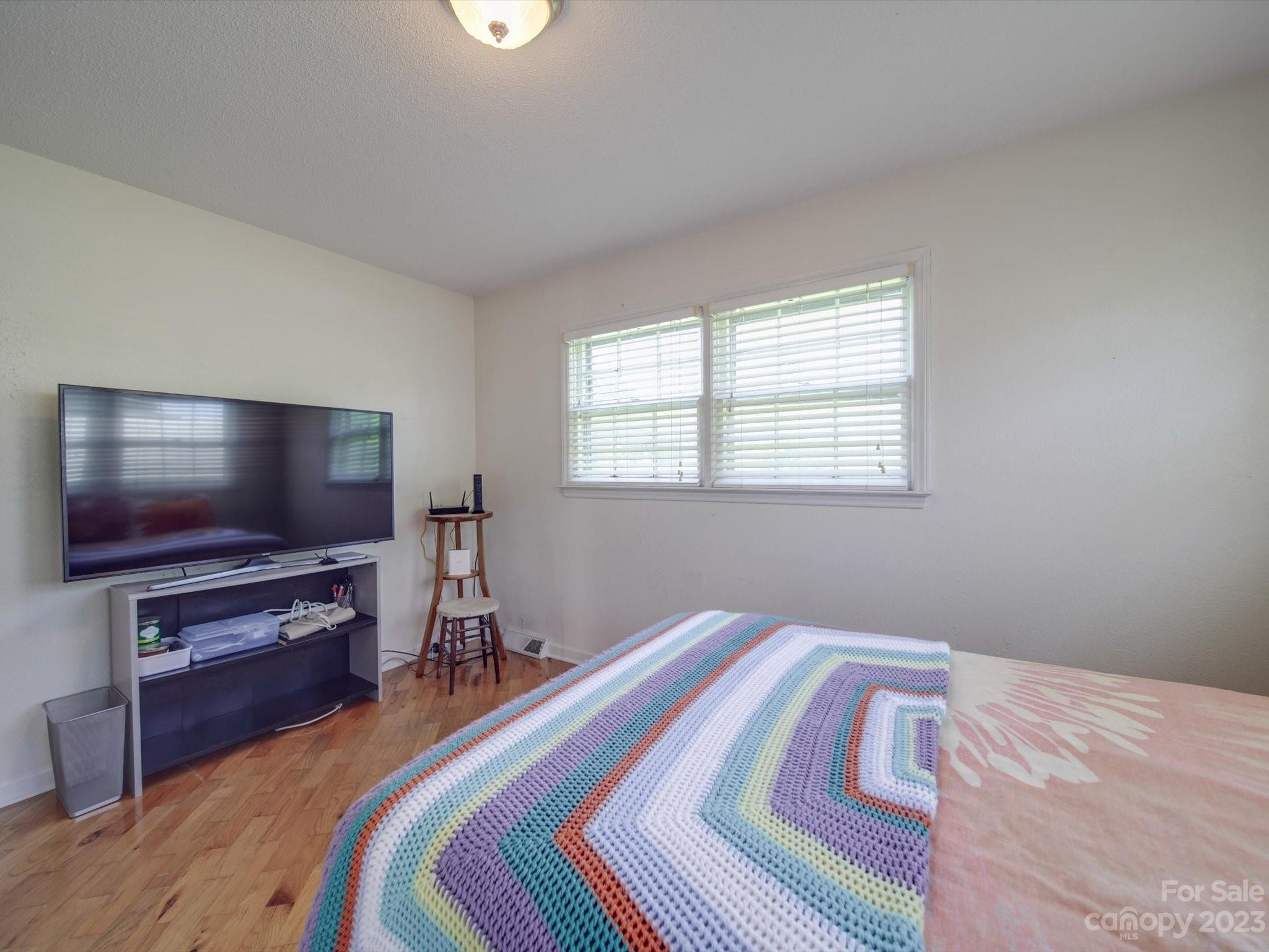 1004 Austin Chaney Road Wingate, NC 28174 - Photo 31 of 48 a bedroom with a bed and a flat screen tv