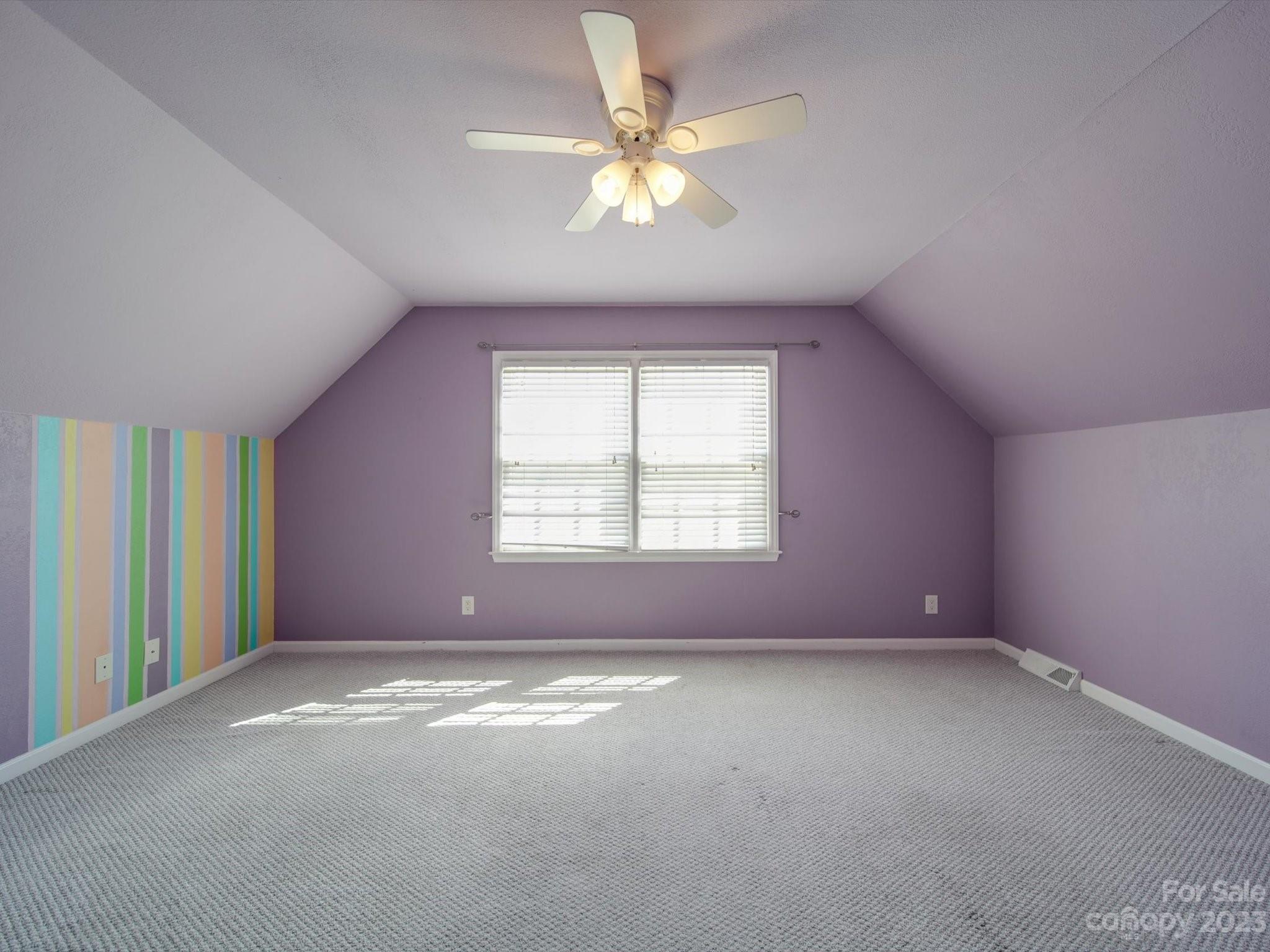 1004 Austin Chaney Road Wingate, NC 28174 - Photo 34 of 48 an empty room with a chandelier fan and windows