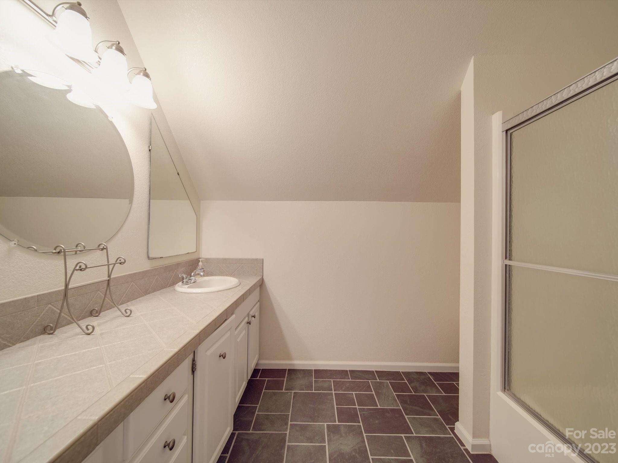 1004 Austin Chaney Road Wingate, NC 28174 - Photo 39 of 48 a spacious bathroom with a double vanity sink and a mirror