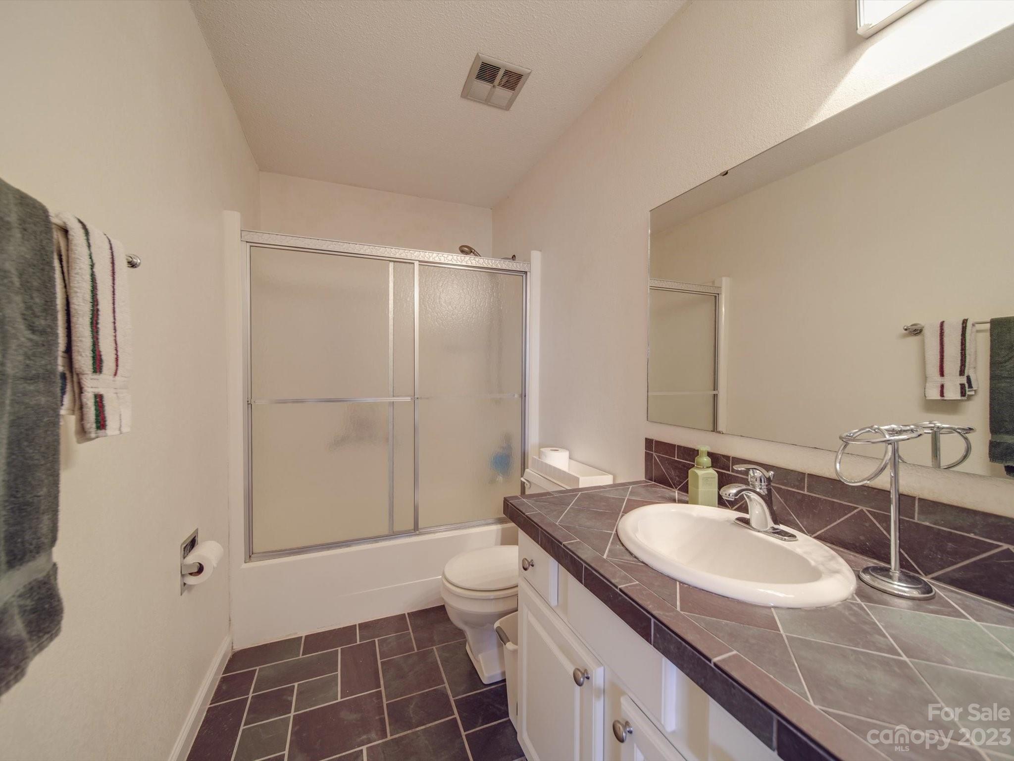 1004 Austin Chaney Road Wingate, NC 28174 - Photo 41 of 48 a bathroom with a sink toilet double vanity and shower