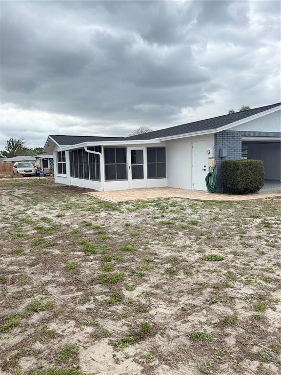 10433 Laburnum Drive Port Richey, FL 34668 - Photo 26 of 26 a front view of a house with yard