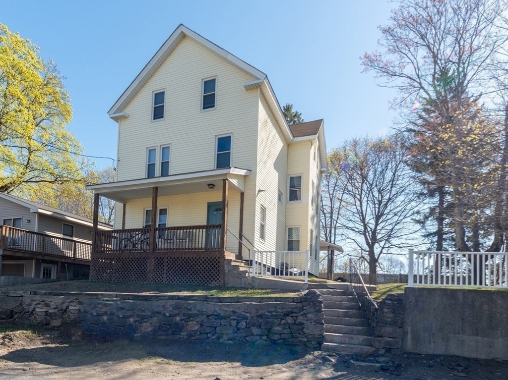 a view of a white house with large windows
