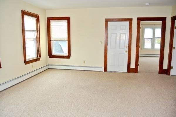 21 Maple Street Clinton, MA 01510 - Photo 13 of 17 an empty room with windows and closet