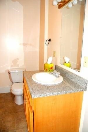 21 Maple Street Clinton, MA 01510 - Photo 16 of 17 a bathroom with a granite countertop sink and a mirror