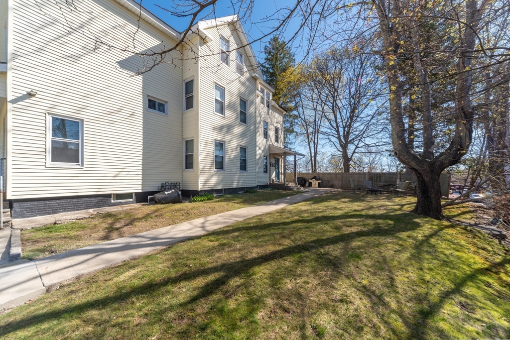 21 Maple Street Clinton, MA 01510 - Photo 4 of 17 a view of a house with a yard and sitting area