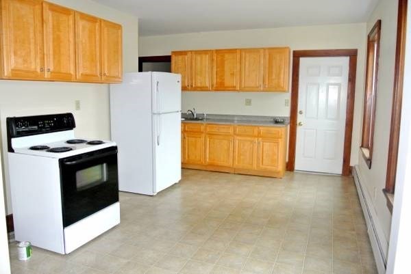21 Maple Street Clinton, MA 01510 - Photo 8 of 17 a kitchen with stainless steel appliances a refrigerator sink and stove