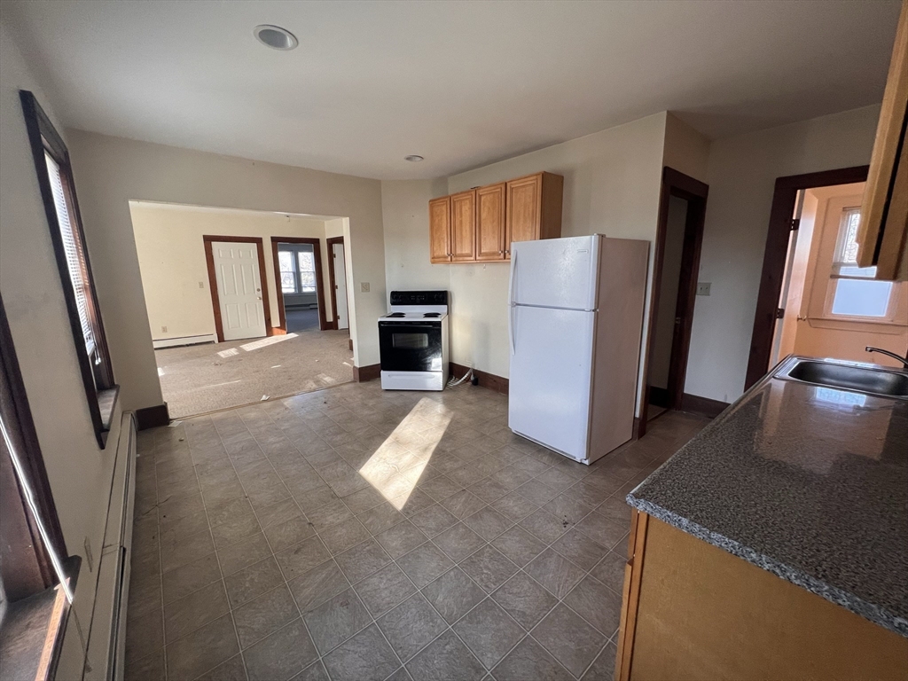 21 Maple Street Clinton, MA 01510 - Photo 10 of 17 a view of livingroom with furniture and a window