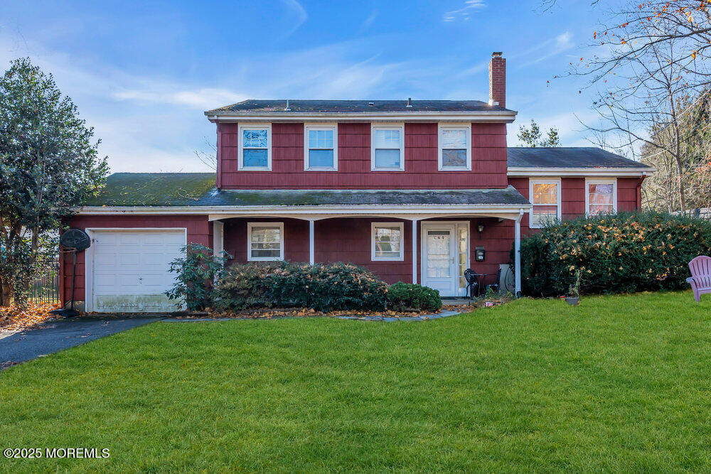 a front view of a house with a garden and yard