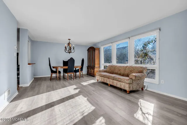 a living room with furniture and a dining table