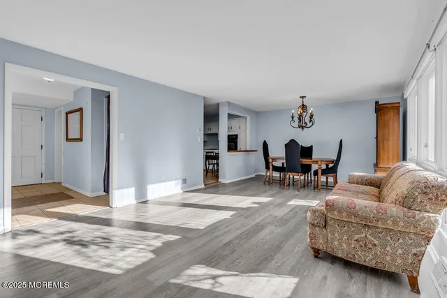 a living room with furniture and a dining table