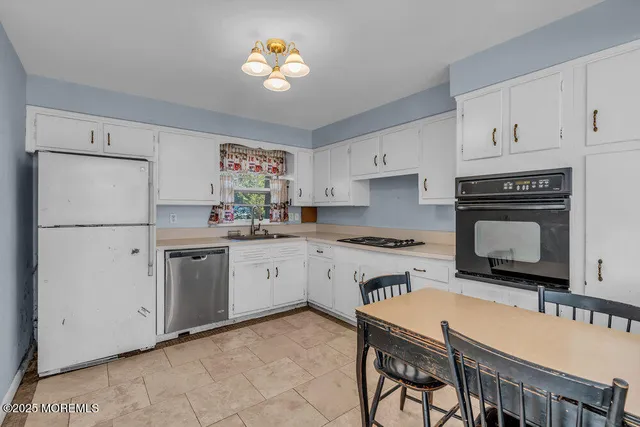 a kitchen with cabinets and stainless steel appliances