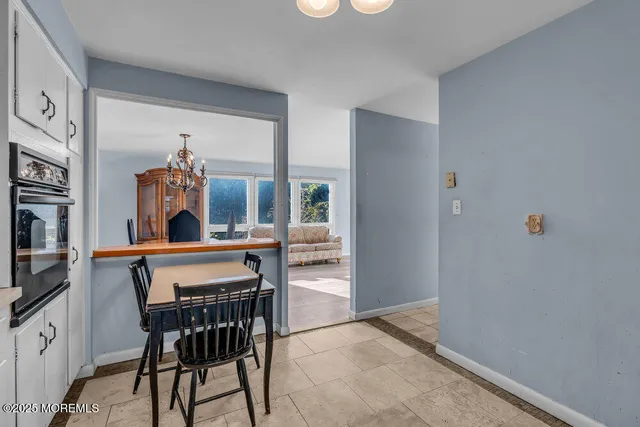 a view of a dining room with furniture and window