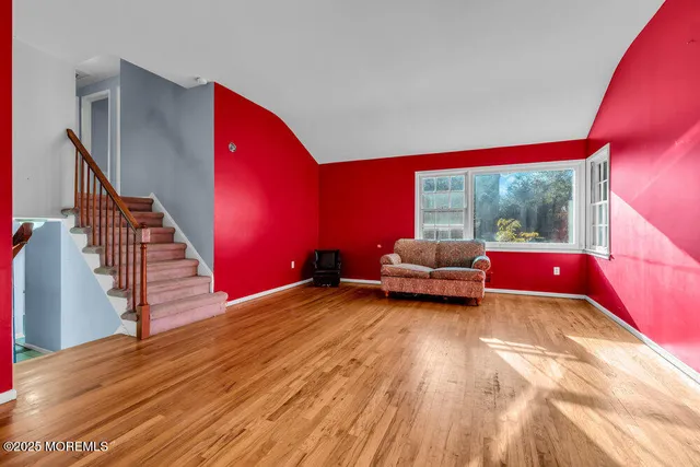 a living room with furniture and a floor to ceiling window