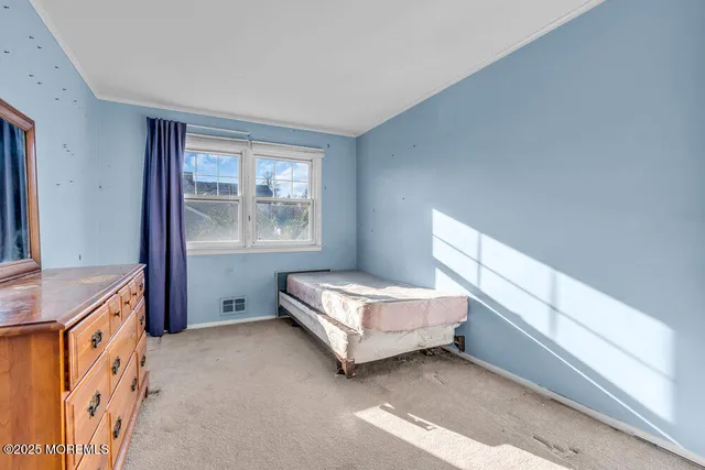 a spacious bedroom with a bed and a window