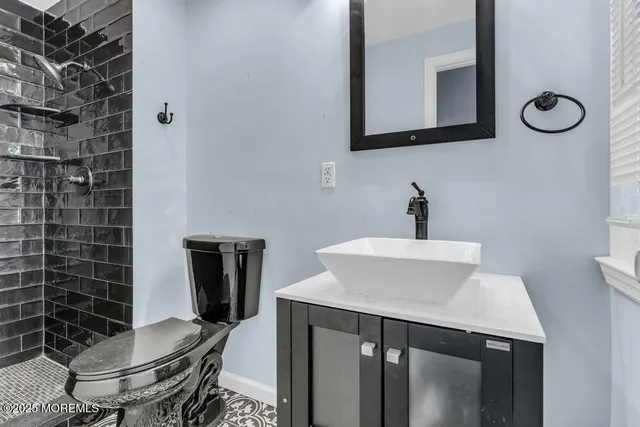 a bathroom with a sink a toilet and mirror