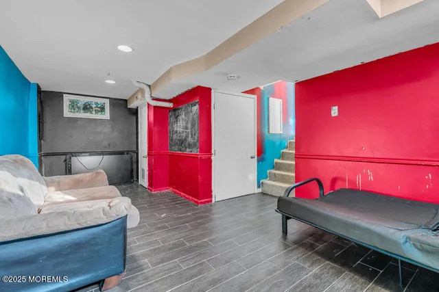 a bedroom with furniture and a mirror