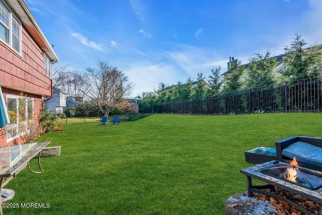 a view of backyard with seating area and green space
