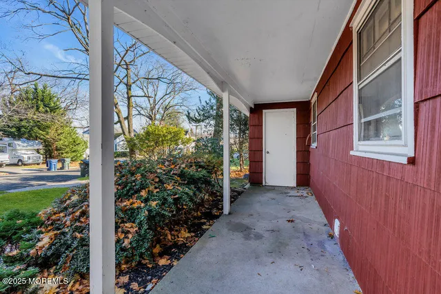 a view of a pathway of a house with flower plants