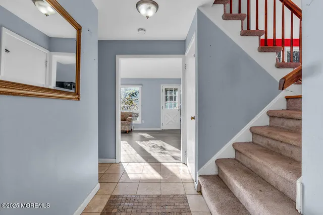 a view of a hallway with entryway and kitchen view