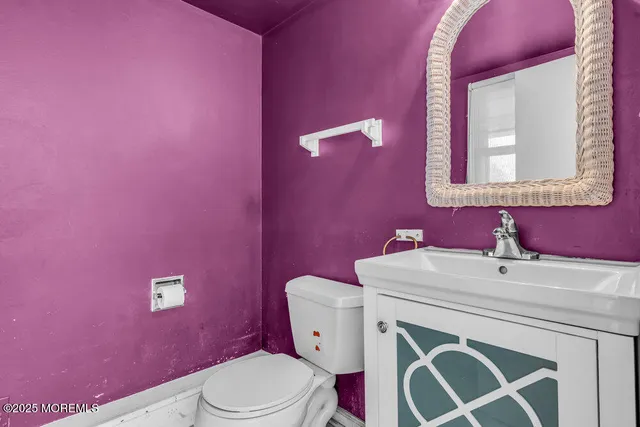 a bathroom with a sink a toilet and mirror