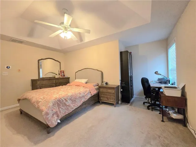 a bedroom with a bed chair and a chandelier