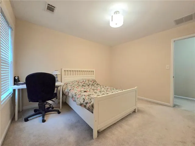 a bedroom with a bed and a desk