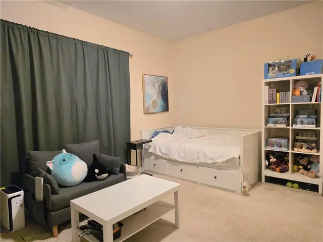 a bedroom with bed and a book shelf
