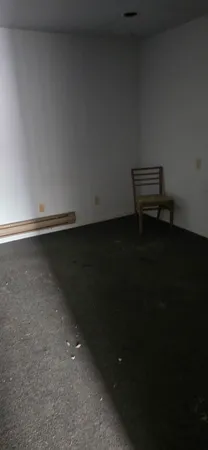 a view of an empty room and wooden floor