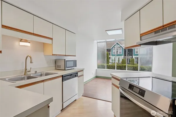 a kitchen that has a sink and a stove