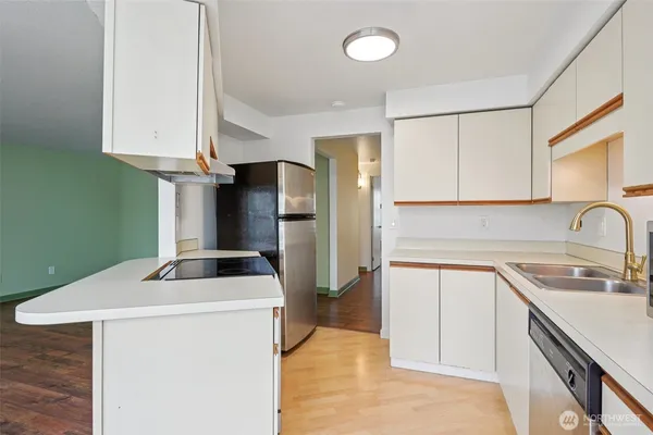 a kitchen with stainless steel appliances a refrigerator sink and cabinets