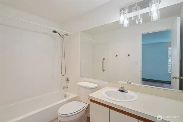 a bathroom with a sink toilet tub and shower